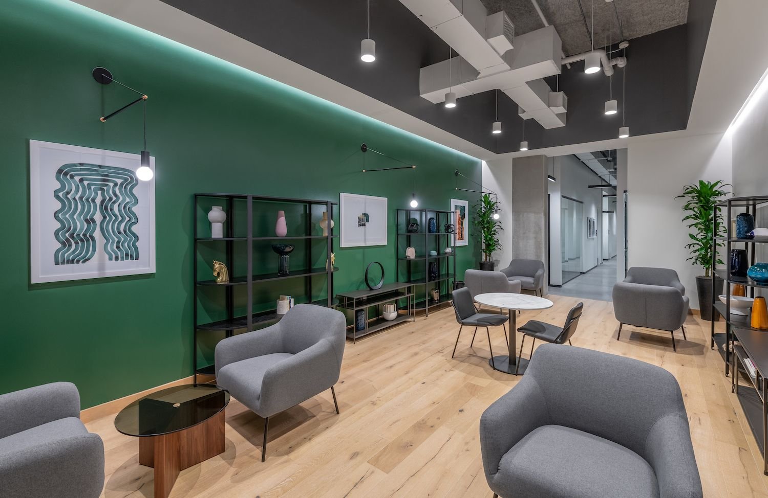 A thoughtfully decorated office break area features cylinder pendant lighting.